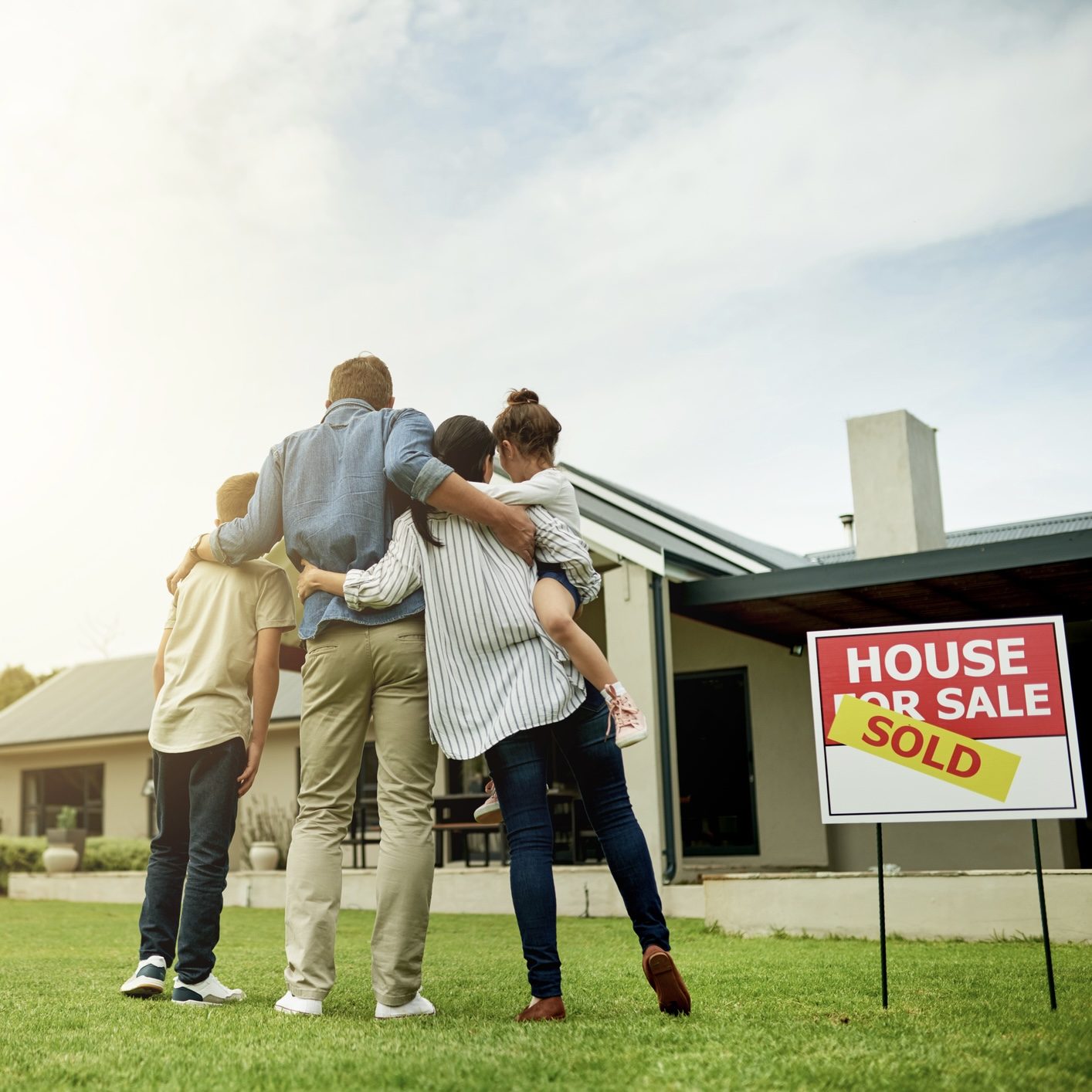 Shot of a family of four viewing their new home together